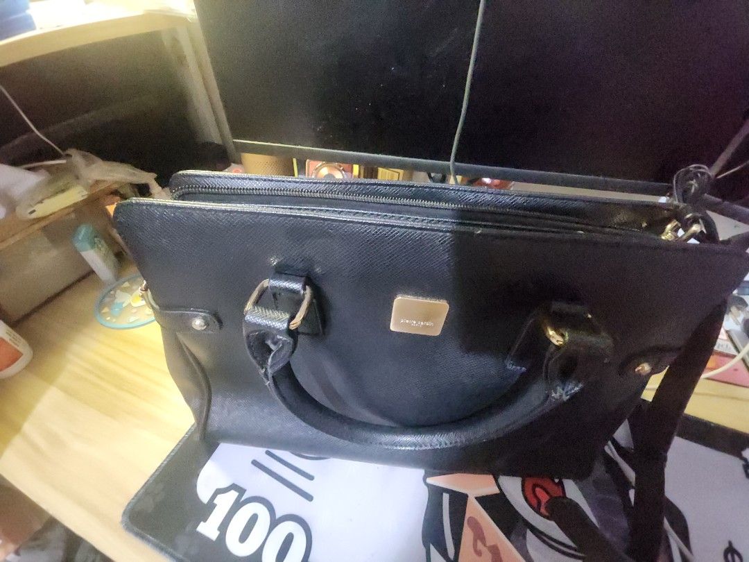 Pierre cardin 2-way black leather bag (Category: Luxury Bags & Wallets) located in Caloocan City. Submitted by zamstak (Listing ID 1459523495, Image 2). Description: pierre cardin 2 way bag - Classic black handbag - Textured leather material - Elegant gold hardware details - Comfortable top handles - Includes a detachable shoulder strap for versatility - Secure zipped main compartment - Internal pockets for organization - Ample space for your ess