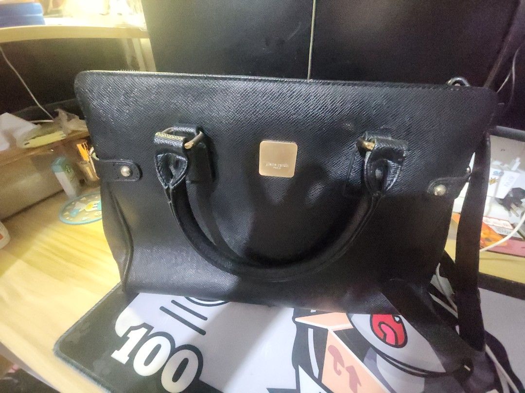 Pierre cardin 2-way black leather bag (Category: Luxury Bags & Wallets) located in Caloocan City. Submitted by zamstak (Listing ID 1459523495, Image 3). Description: pierre cardin 2 way bag - Classic black handbag - Textured leather material - Elegant gold hardware details - Comfortable top handles - Includes a detachable shoulder strap for versatility - Secure zipped main compartment - Internal pockets for organization - Ample space for your ess