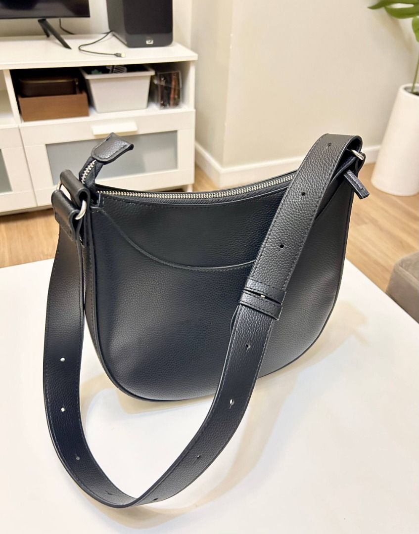 Black Pebbled Vegan Leather Crescent Shoulder Bag (Category: Shoulder Bags) located in Manila. Submitted by softlysorted (Listing ID 1459626142, Image 1). Description: Minimalist black shoulder bag with a curved hobo-style silhouette—easy to pair with casual, office, or everyday outfits. • Textured pebbled leather-like exterior • Wide shoulder strap • Secure top-zip closure • Silver-tone hardware • Fully lined interior • Spacious enough for every
