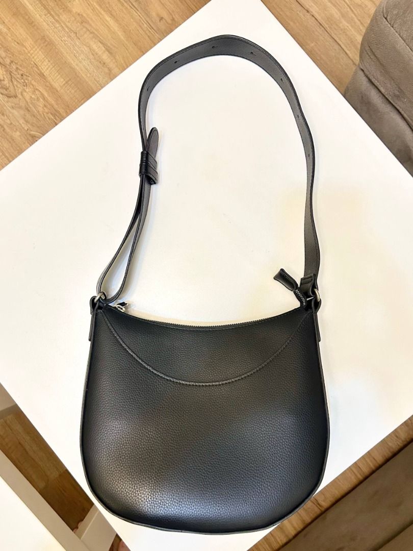 Black Pebbled Vegan Leather Crescent Shoulder Bag (Category: Shoulder Bags) located in Manila. Submitted by softlysorted (Listing ID 1459626142, Image 3). Description: Minimalist black shoulder bag with a curved hobo-style silhouette—easy to pair with casual, office, or everyday outfits. • Textured pebbled leather-like exterior • Wide shoulder strap • Secure top-zip closure • Silver-tone hardware • Fully lined interior • Spacious enough for every