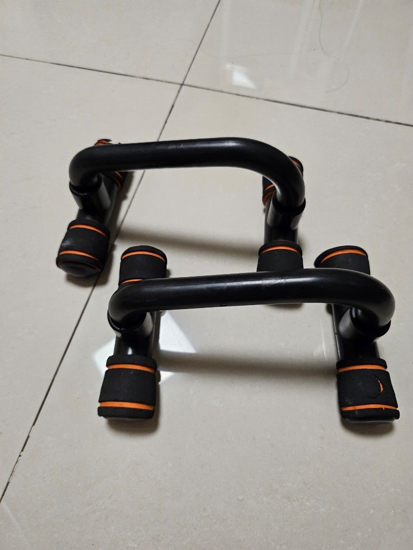 Black Push Up Bars with Orange Grips (Category: Other Sports Equipment and Supplies) located in Manila. Submitted by minimalistbyheart (Listing ID 1459626158, Image 1). Description: bgc uptown / mitsukoshi meet up - Pair of black push up bars - Orange padded grips for enhanced comfort - Ideal for home workouts - Targets chest, shoulders, and triceps - Sturdy and durable construction - Note: Minor wear on grips.