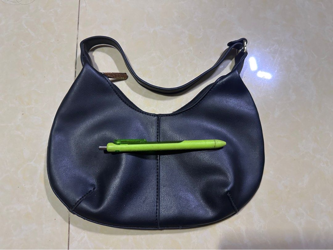 Black Shoulder Bag (Category: Shoulder Bags) located in Mandaluyong City. Submitted by greenapple14 (Listing ID 1459629766, Image 1). Description: - Stylish black shoulder bag - Classic crescent moon shape - Made of faux leather material - Secure zipper closure - Small gold-tone logo tag on strap - Ideal for everyday use.