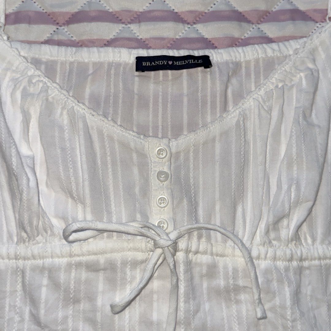 brandy melville tiffany top (Category: Others Tops) located in Bauang. Submitted by meow.dcltr (Listing ID 1459530125, Image 3). Description: brandy melville tiffany top - white one size length: 16.5 inches *excluding strap width: 15.5 inches • adjustable straps & 1 extra button no issues/flaws. 100% authentic. from hk pasabuy. no ww photo.