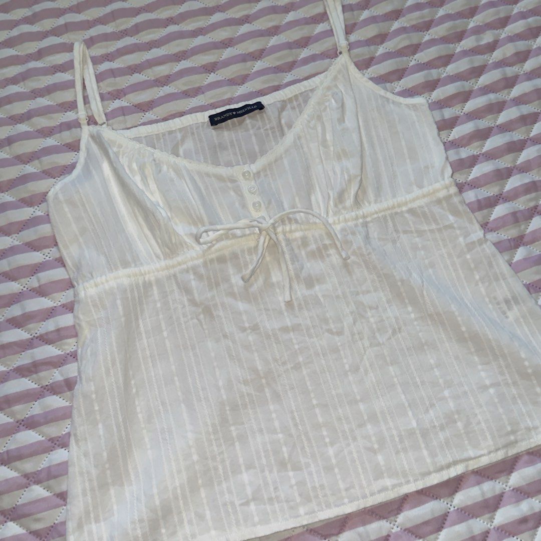 brandy melville tiffany top (Category: Others Tops) located in Bauang. Submitted by meow.dcltr (Listing ID 1459530125, Image 2). Description: brandy melville tiffany top - white one size length: 16.5 inches *excluding strap width: 15.5 inches • adjustable straps & 1 extra button no issues/flaws. 100% authentic. from hk pasabuy. no ww photo.