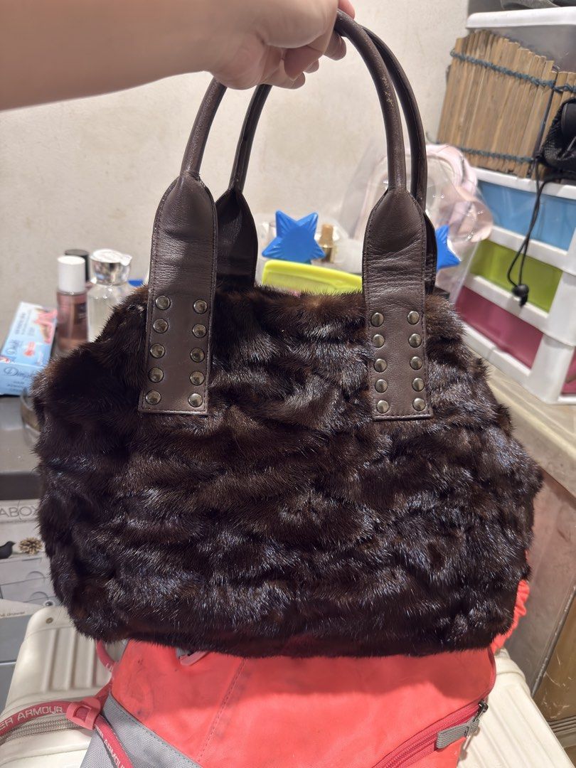 Brown Fur Handbag with Leather Straps (Category: Luxury Bags & Wallets) located in Quezon City. Submitted by katrinaroncales_ (Listing ID 1459618872, Image 2). Description: - Dark brown furry handbag - Genuine leather handles with metal stud details - Secure zipper closure - Interior zippered pocket - Authentic 'Yoshinoya' gold-tone brand tag - Unique texture and design for a statement look - Keri siya for shoulder bag if maliit braso - Flaws: Ma