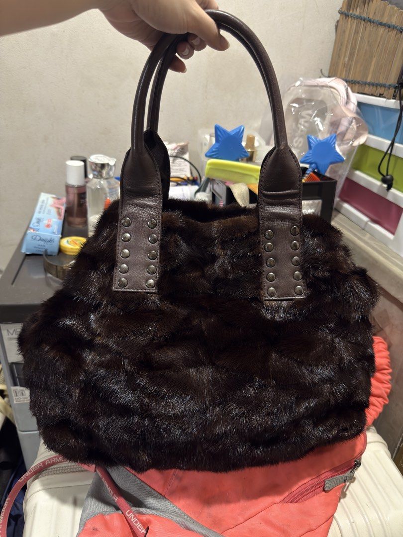 Brown Fur Handbag with Leather Straps (Category: Luxury Bags & Wallets) located in Quezon City. Submitted by katrinaroncales_ (Listing ID 1459618872, Image 1). Description: - Dark brown furry handbag - Genuine leather handles with metal stud details - Secure zipper closure - Interior zippered pocket - Authentic 'Yoshinoya' gold-tone brand tag - Unique texture and design for a statement look - Keri siya for shoulder bag if maliit braso - Flaws: Ma