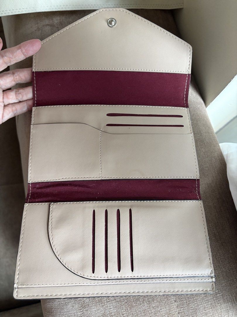 Brown Leather Envelope Wallet with Card Slots (Category: Wallets & Card holders) located in Taguig. Submitted by styledamsel (Listing ID 1459557280, Image 2). Description: - Chic brown leather wallet - Unique envelope closure - Deep red interior lining - Beige lining with multiple card slots and compartments - Ample space for cards and cash - Perfect for organizing your essentials Genuine Leather .