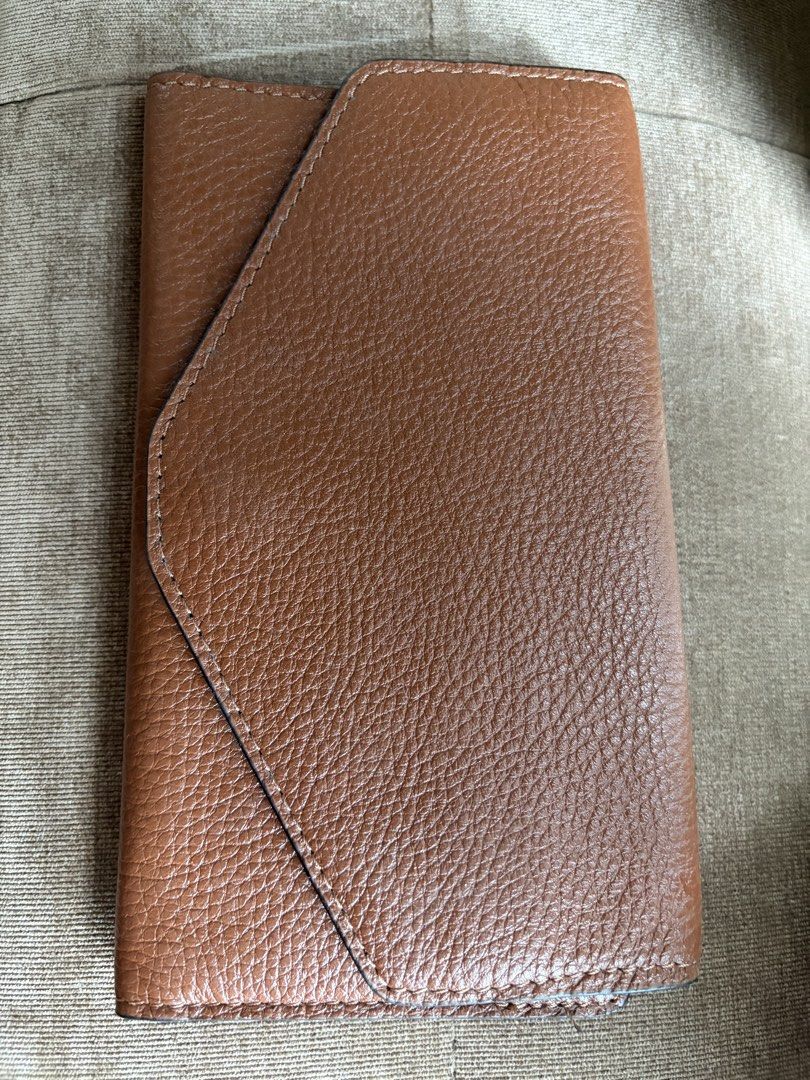 Brown Leather Envelope Wallet with Card Slots (Category: Wallets & Card holders) located in Taguig. Submitted by styledamsel (Listing ID 1459557280, Image 1). Description: - Chic brown leather wallet - Unique envelope closure - Deep red interior lining - Beige lining with multiple card slots and compartments - Ample space for cards and cash - Perfect for organizing your essentials Genuine Leather .