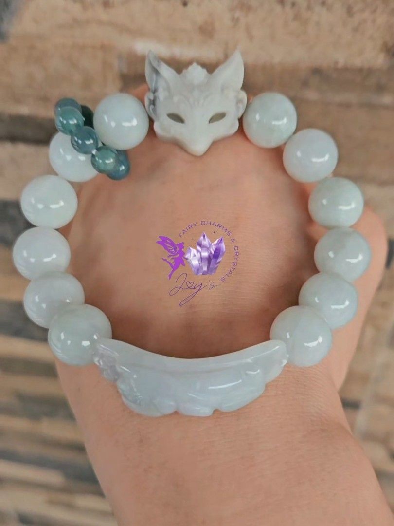 Burmese Jade with Fox Mask Agate Bracelet (Category: Other Accessories) located in Manila. Submitted by mommyjoycrystals (Listing ID 1459505061, Image 1). Description: - Beautiful bracelet, approximately 18cm long. - Features a unique white fox mask charm. - Adorned with light green jade beads. - Includes a carved moon charm. - Some darker green beads are also incorporated for added detail. - A truly unique piece for your jewelry collection..