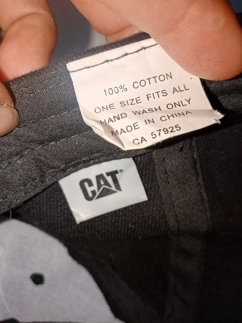 Caterpillar CAT Logo Black Cotton Baseball Cap (Category: Caps & Hats) located in Allen. Submitted by milyonaryung_gipit (Listing ID 1459517071, Image 2). Description: - Authentic Black Caterpillar CAT Cap - Made from 100% Cotton - One Size Fits All - Iconic CAT logo embroidered on the front - Yellow stitching detail on the brim - Care Instructions: Hand wash only - Ideal for any CAT fan or enthusiast.