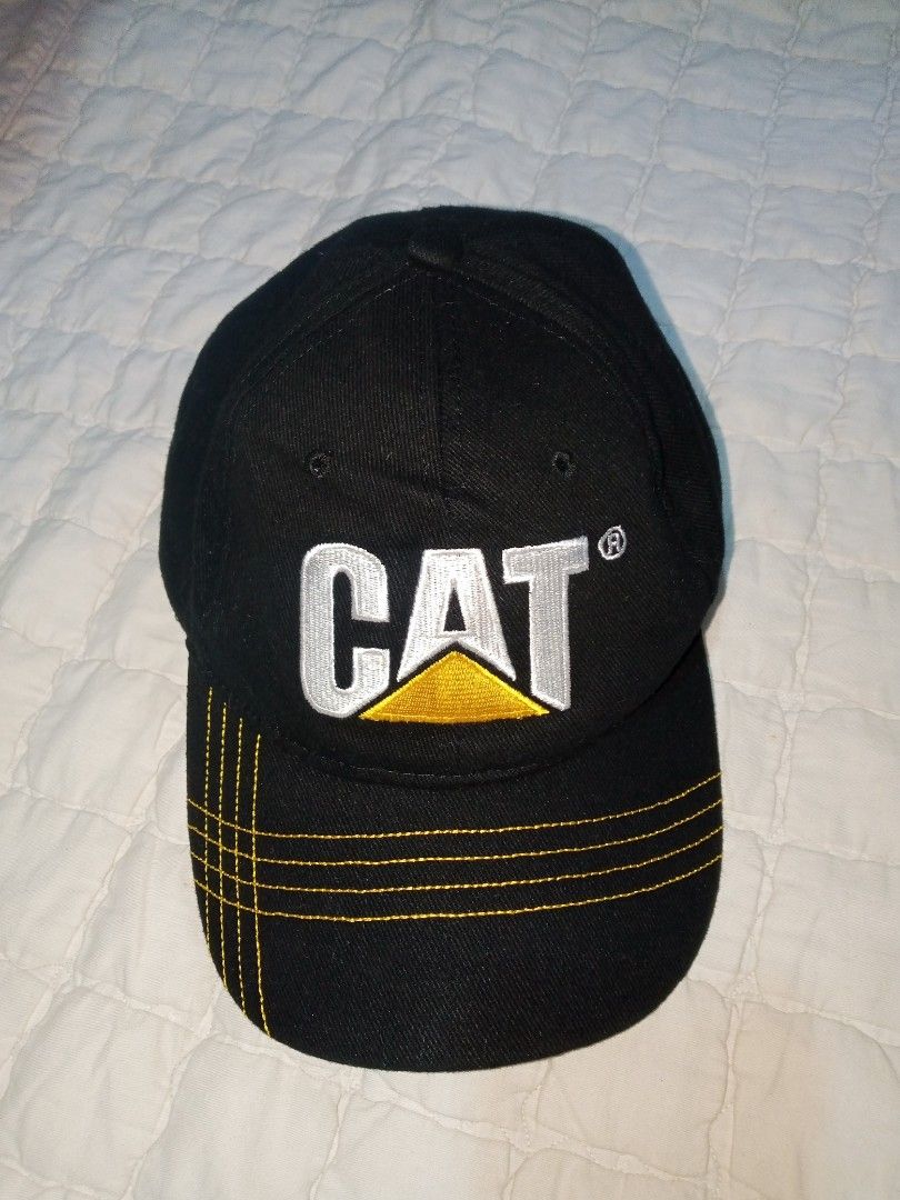 Caterpillar CAT Logo Black Cotton Baseball Cap (Category: Caps & Hats) located in Allen. Submitted by milyonaryung_gipit (Listing ID 1459517071, Image 1). Description: - Authentic Black Caterpillar CAT Cap - Made from 100% Cotton - One Size Fits All - Iconic CAT logo embroidered on the front - Yellow stitching detail on the brim - Care Instructions: Hand wash only - Ideal for any CAT fan or enthusiast.