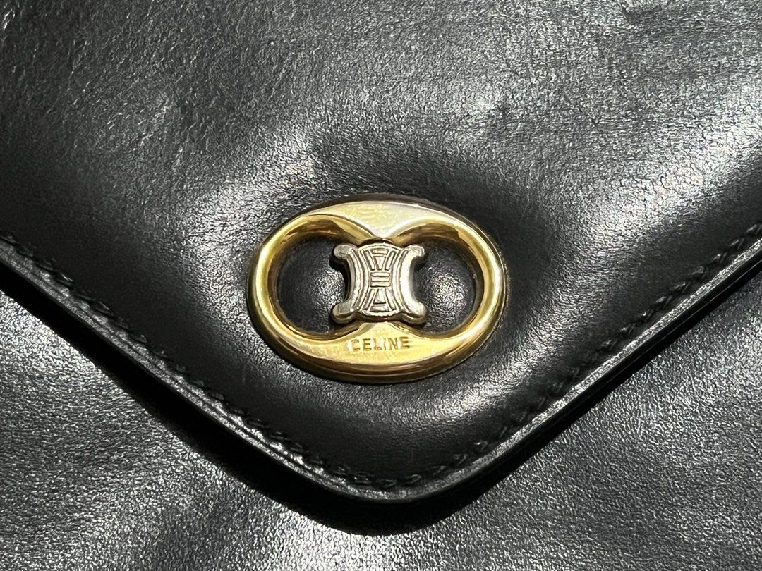 Celine Black Leather Envelope Clutch Bag with Triomphe Logo (Category: Luxury Bags & Wallets) located in Dagupan City. Submitted by casadebayongph (Listing ID 1459533582, Image 3). Description: - Classic Celine black leather envelope clutch - Iconic gold Triomphe logo hardware - Ideal for evening wear or as a statement piece - Minor signs of wear on leather, consistent with use. Hole on side for sling slot. - Clean interior - Timeless accessory.