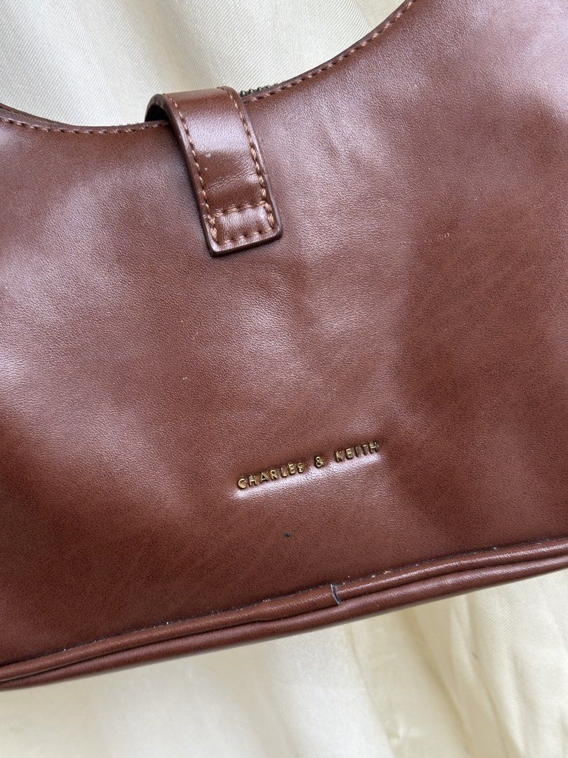 Charles & Keith Brown Shoulder Bag (Category: Shoulder Bags) located in Baguio. Submitted by roxstvrs. (Listing ID 1459687322, Image 2). Description: - Brand: Charles & Keith - Color: Brown - Style: Shoulder Bag - Closure: Zip - Interior: 1 zip pocket, 1 slip pocket - Hardware: Gold-tone - Perfect for: Everyday use, carrying essentials.