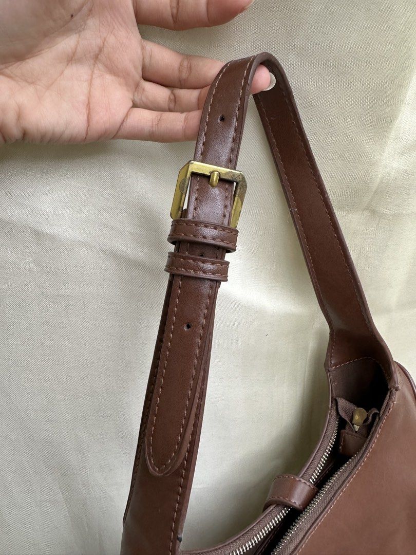 Charles & Keith Brown Shoulder Bag (Category: Shoulder Bags) located in Baguio. Submitted by roxstvrs. (Listing ID 1459687322, Image 3). Description: - Brand: Charles & Keith - Color: Brown - Style: Shoulder Bag - Closure: Zip - Interior: 1 zip pocket, 1 slip pocket - Hardware: Gold-tone - Perfect for: Everyday use, carrying essentials.