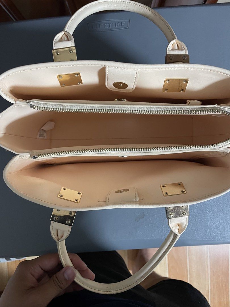 Charles & Keith Cream Canvas Top Handle Bag (Category: Luxury Bags & Wallets) located in Las Pinas. Submitted by gabriel0123 (Listing ID 1459647101, Image 3). Description: - Cream canvas handbag - Genuine leather trim - Elegant gold hardware details - Secure top zip closure - Multiple interior compartments for organization - Includes a small matching tag - Need cleaning - Ideal for everyday use.