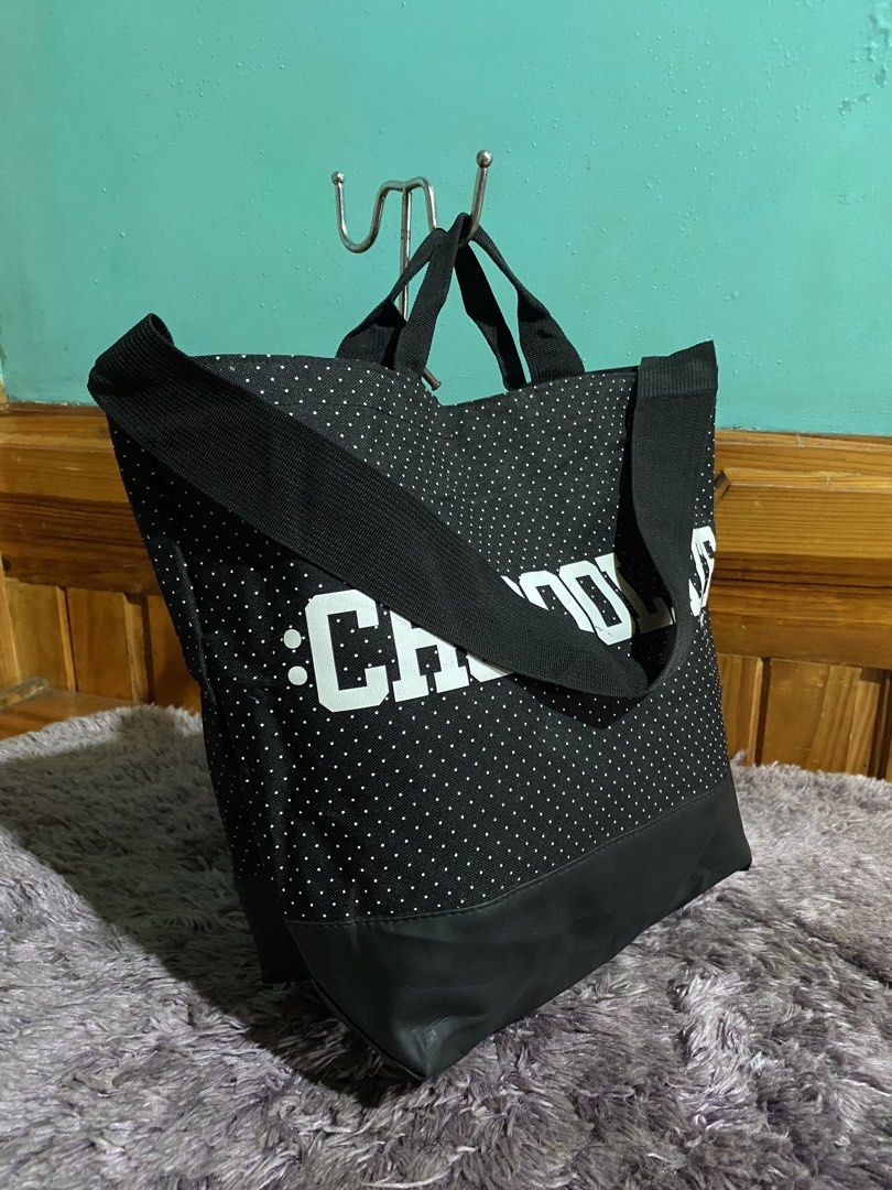 CHOCOLATE Tote Bag Polka Dot Black (Category: Tote Bags) located in La Trinidad. Submitted by kinleyky (Listing ID 1459617822, Image 2). Description: - Stylish black tote bag with playful white polka dots. - Features a large, eye-catching 'CHOCOLATE' graphic on the front. - Durable black base and comfortable black handles. - Includes interior pockets to keep your essentials organized. - Secure snap button closure. - Ideal for everyday use, shoppi