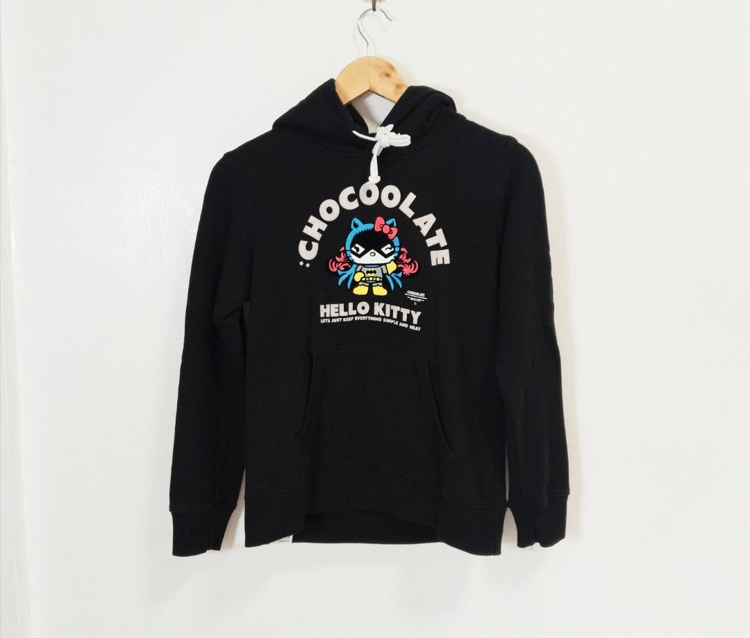 CHOCOOLATE x Hello Kitty Hoodie Black XS (Category: Coats, Jackets and Outerwear) located in Pateros City. Submitted by blashjunks.y2k (Listing ID 1459553824, Image 2). Description: - Brand: Chocoolate x Kitty collaboration - Item: Black Hoodie - Size: XS - Design: "Cool" graphic print of Kitty dressed as Batman - Features: Front pocket, drawstring hood - Perfect for: Kitty and Chocoolate fans.