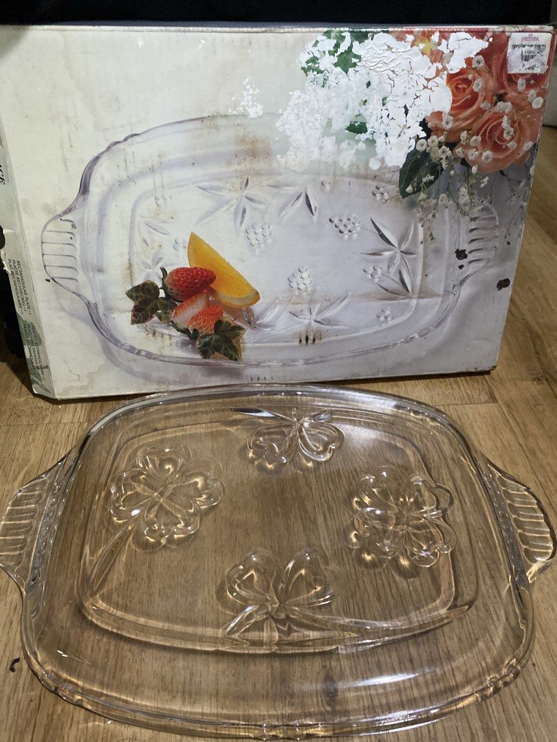 Clear Glass Serving Platter with Embossed Clover Design (Category: Dinnerware & Cutlery) located in Taguig. Submitted by cosmickindle (Listing ID 1459570879, Image 3). Description: - Rectangular glass platter - Features handles on both sides for easy carrying - Four embossed clover designs on the surface - Ideal for serving snacks or desserts - Approximate dimensions: 12 inches long x 8 inches wide - Slightly negotiable - RFS: Not in use **First 