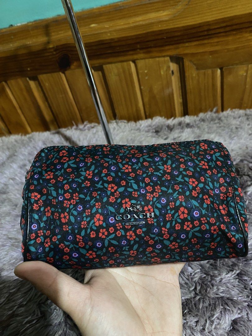 Coach Floral Cosmetic Bag Pouch (Category: Luxury Bags & Wallets) located in La Trinidad. Submitted by kinleyky (Listing ID 1459618046, Image 2). Description: - Cute Coach cosmetic bag - Features a dark floral print with red and purple flowers - Zipper closure - Ideal for makeup or small essentials - Compact and easy to carry.