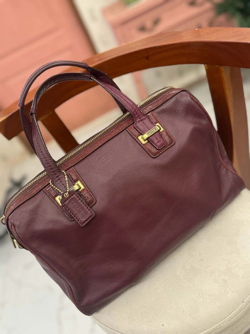Coach Leather Handbag Burgundy (Category: Luxury Bags & Wallets) located in Bacolod City. Submitted by vintage_vogue6100 (Listing ID 1459542450, Image 2). Description: Burgundy leather handbag from Coach. Gold hardware details. Zipper closure. Comes with original Coach hang tags. .