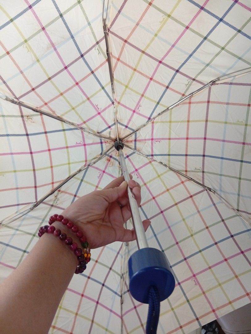 Coach Plaid Folding Umbrella (Category: Umbrellas) located in Davao. Submitted by lingxu23 (Listing ID 1459505106, Image 2). Description: - Authentic Coach folding umbrella - Eye-catching colorful plaid pattern - Compact and portable design, ideal for everyday carry - Features a stylish blue handle and strap - Secure snap closure - Coach logo detail on the strap - Essential for staying dry on rainy days.