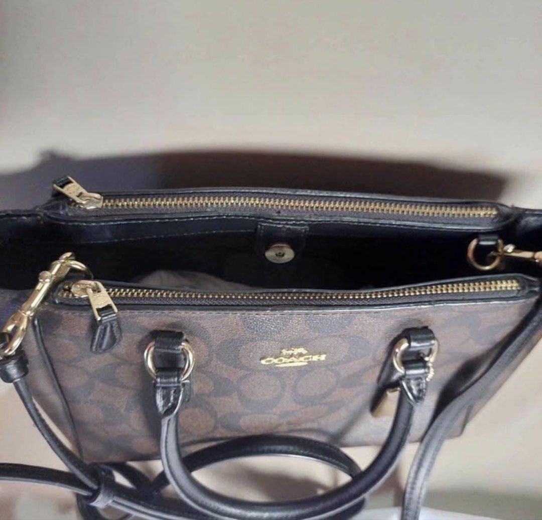 Coach Signature Monogram Satchel Bag (Category: Luxury Bags & Wallets) located in Andop. Submitted by nikiprelove55563 (Listing ID 1459516183, Image 2). Description: - Authentic Coach satchel bag - Signature monogram print in brown and black - Elegant gold hardware - Features both top handles and a detachable crossbody strap for versatile carrying - Secure zipper closure - Spacious interior with multiple compartments for organization - Comes with