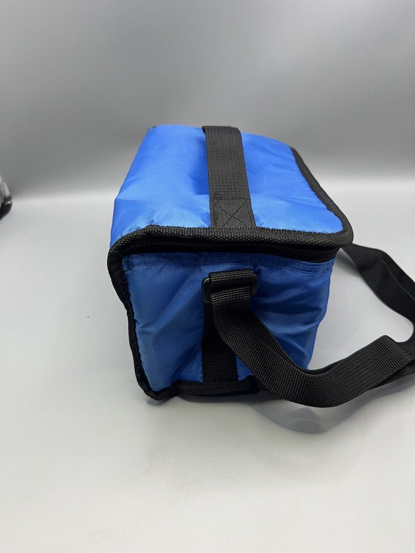Coleman Blue Cooler Bag with Strap (Category: Hiking & Camping) located in Manila. Submitted by homegrwn_thrift (Listing ID 1459638826, Image 3). Description: - Blue Coleman cooler bag - Insulated interior for keeping items cold - Convenient shoulder strap for easy carrying - Ideal for picnics, outings, or beach trips - Secure zip closure.
