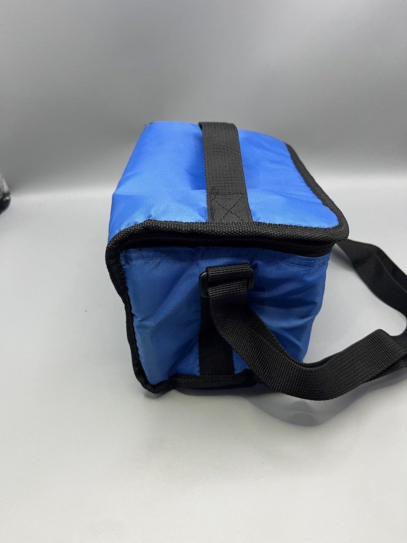 Coleman Blue Cooler Bag with Strap (Category: Hiking & Camping) located in Manila. Submitted by homegrwn_thrift (Listing ID 1459638826, Image 2). Description: - Blue Coleman cooler bag - Insulated interior for keeping items cold - Convenient shoulder strap for easy carrying - Ideal for picnics, outings, or beach trips - Secure zip closure.