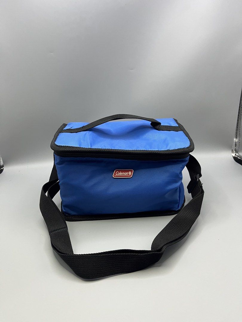 Coleman Blue Cooler Bag with Strap (Category: Hiking & Camping) located in Manila. Submitted by homegrwn_thrift (Listing ID 1459638826, Image 1). Description: - Blue Coleman cooler bag - Insulated interior for keeping items cold - Convenient shoulder strap for easy carrying - Ideal for picnics, outings, or beach trips - Secure zip closure.