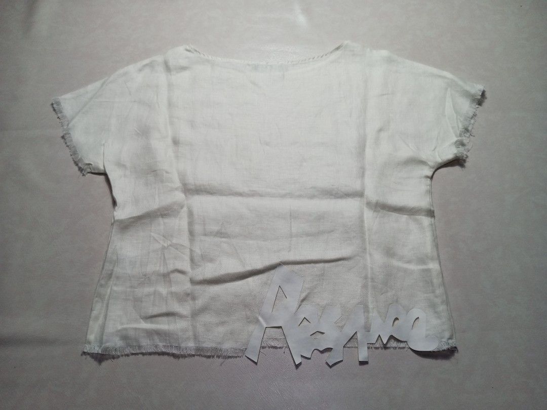 Cop Copine White Linen Frayed Hem Top Authentic (Category: Luxury Apparel) located in Urdaneta. Submitted by josephragontonjr95 (Listing ID 1459602335, Image 2). Description: - Cop Copine White Linen Frayed Hem Top Authentic - SIZE: 36 - DIMENSIONS ⬇️ ⬇️ ⬇️ - WIDTH: 20 - LENGTH: 22.5 - COLOR RATE: 9.8/10 - ISSUES/FLAWS: NONE - CONDITION: AS NEW - Color: White - Material: Linen - Sleeve Style: Short sleeves with frayed edges - Hem Details: Frayed 