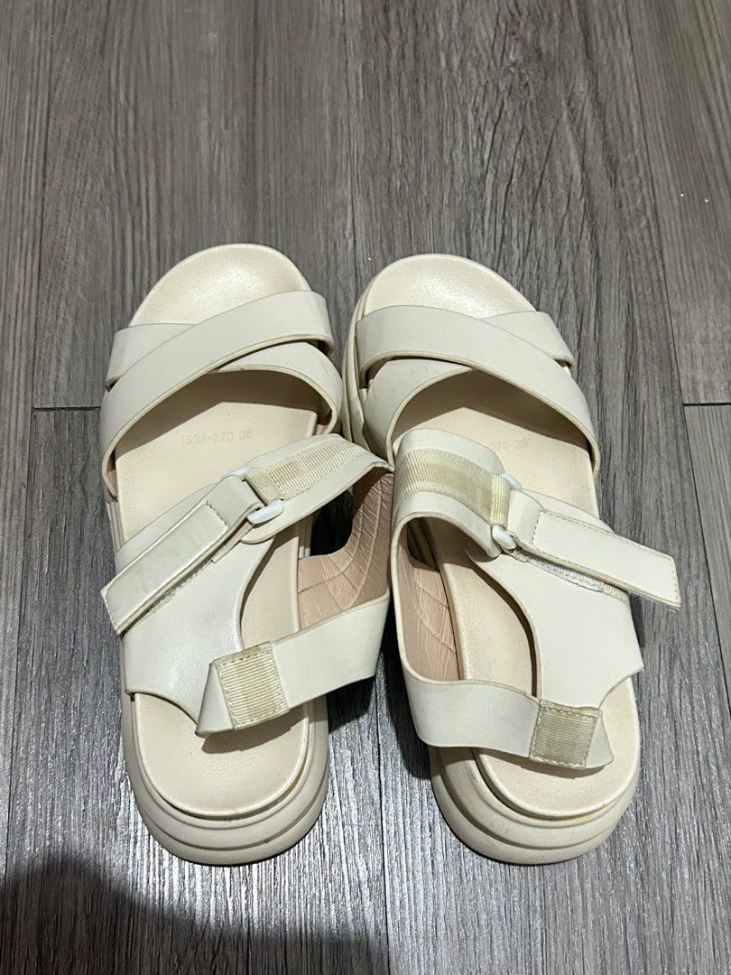 Cream Platform Sandals with Cross Straps (Category: Flats & Sandals) located in San Juan City. Submitted by nina1422 (Listing ID 1459573034, Image 2). Description: - Cream colored platform sandals - Criss-cross straps over the foot - Adjustable ankle straps with buckle closure - Chunky sole for added height and comfort - Easy slip-on design - Versatile for casual outings and everyday wear - Size 38 - Used once in Japan - MOP: Gcash - Shipping to 