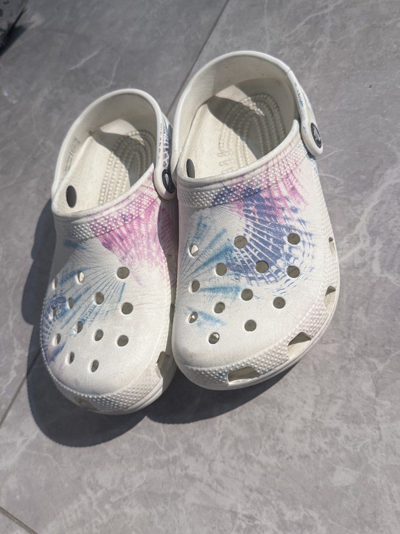 Crocs Tie-Dye Clogs (Category: Slippers & Slides) located in Batangas. Submitted by minimalistthriftshop (Listing ID 1459614797, Image 1). Description: - White Crocs with a cool pink and blue tie-dye pattern. - Classic clog style, easy to slip on and off. - Ideal for casual outings or lounging at home. - Shows minor marks from normal wear. - Looking for a new home!.