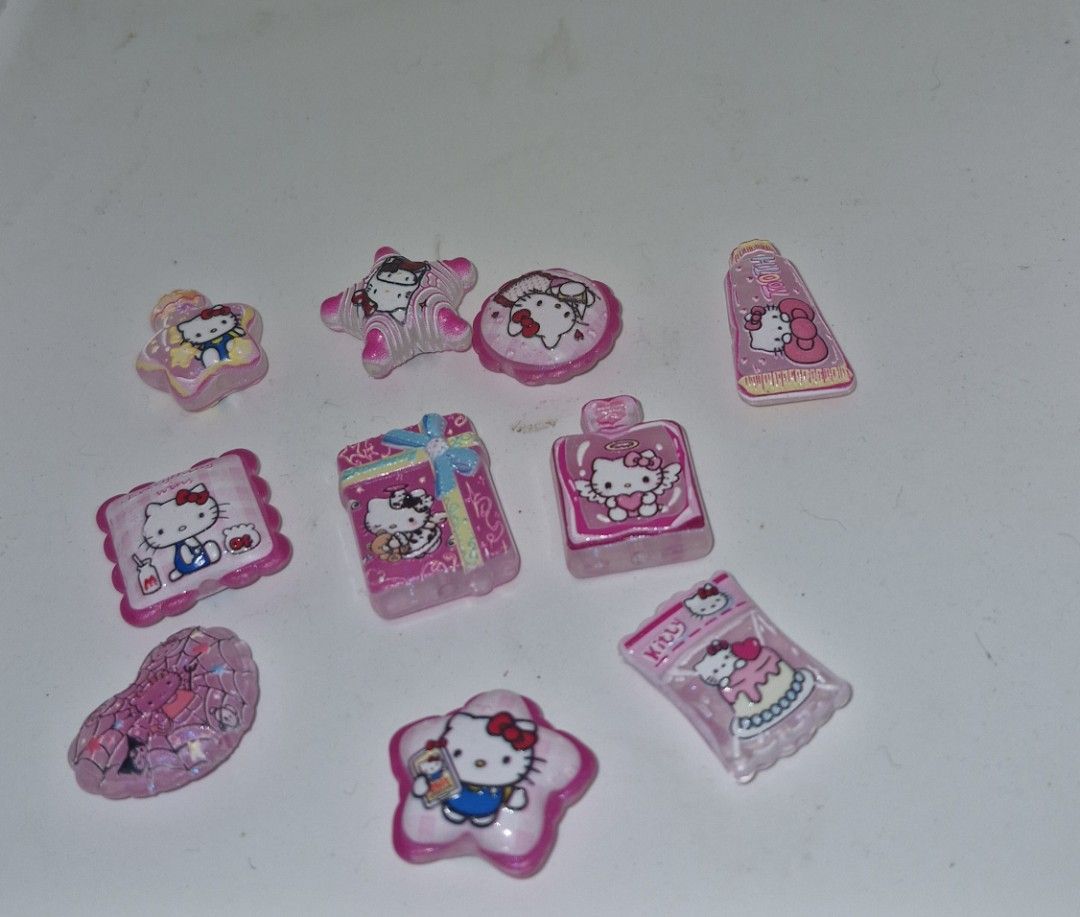Cute Hello Kitty Charms - Various Designs (Category: Charms) located in Quezon City. Submitted by belikabim2014 (Listing ID 1459674543, Image 1). Description: - Get a total of 10 adorable Kitty charms. - Features cute designs: perfume bottle, toothpaste, gift box, stars, and more. - All charms are pink and have a glittery finish. - Ideal for DIY crafts, making jewelry, or decorating phone cases. - Fun and essential accessories for any Kitty enthu