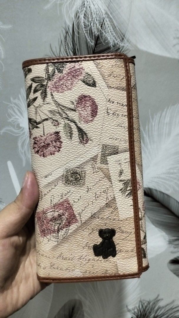 Cute Teddy Bear Floral Wallet (Category: Wallets & Card holders) located in Quezon City. Submitted by borresashl49573 (Listing ID 1459674405, Image 1). Description: - Tan wallet with charming floral and letter print.😍 - Adorable teddy bear charm on the front. ♥️ - Multiple card slots and compartments inside for organization. - Secure zipper closure..