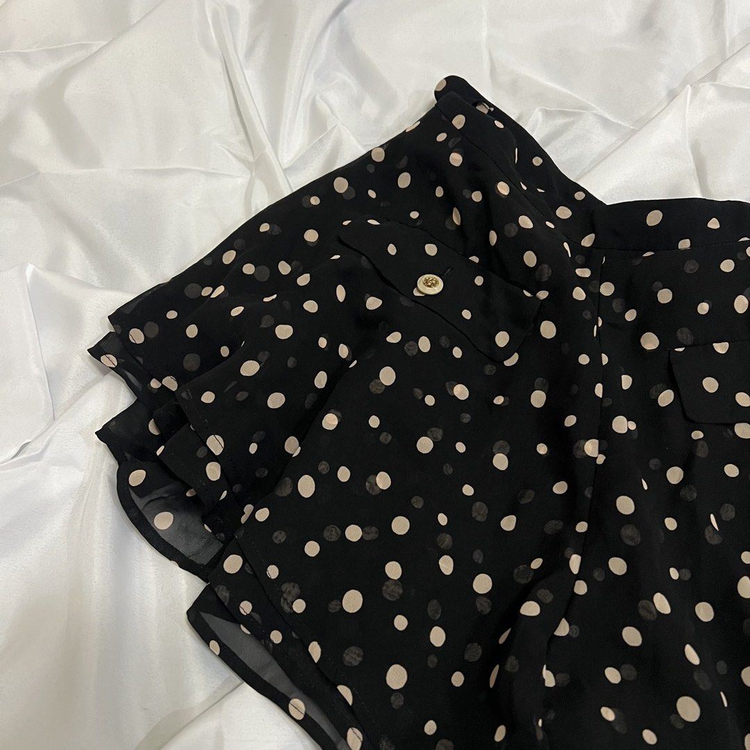 Dazzlin Black Polka Dot Ruffle Shorts (Category: Shorts) located in Imus. Submitted by niftees.eco (Listing ID 1459683774, Image 2). Description: Cute Dazzlin shorts with beige polka dots and a ruffled hem. Features two buttoned front pockets. Perfect for casual outfits. XS-S Size 26.