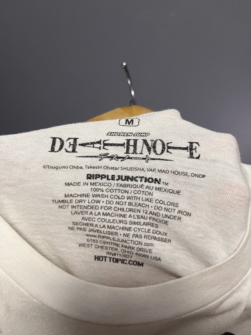Death Note L Anime T-Shirt Size M (Category: Tshirts & Polo Shirts ) located in Cabuyao City. Submitted by bulandos (Listing ID 1459632715, Image 3). Description: - White graphic tee featuring L from Death Note in chibi style. - Includes Japanese text. - Made from 100% cotton. - Brand: Ripple Junction. - Tagged size: Medium (M). - Condition: Small hole on the shoulder area (visible in photos). - Ideal for anime enthusiasts and Death Note fans..
