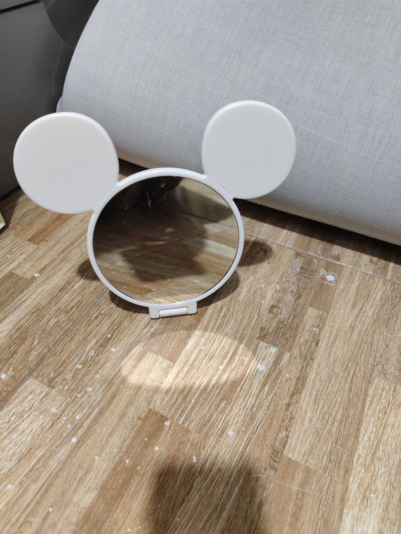 Disney Daiso Mickey Mouse Handheld Mirror (Category: Mirrors) located in Makati City. Submitted by abegailbrezuela (Listing ID 1459587376, Image 1). Description: - Adorable Mickey Mouse inspired handheld mirror - Classic white color with iconic Mickey ears - Foldable handle for convenient storage and use - Compact and portable, ideal for touch-ups anywhere - A must-have accessory for any Disney fan's collection.