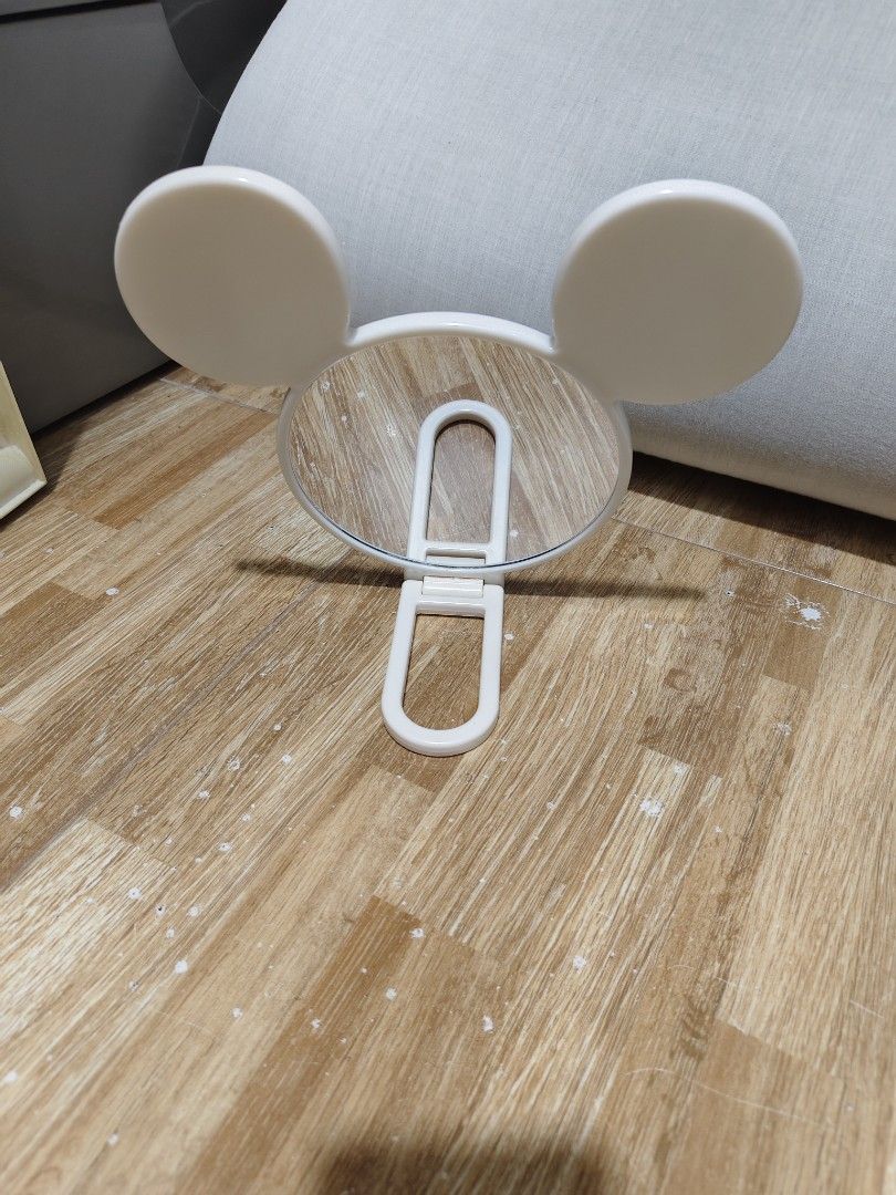Disney Daiso Mickey Mouse Handheld Mirror (Category: Mirrors) located in Makati City. Submitted by abegailbrezuela (Listing ID 1459587376, Image 2). Description: - Adorable Mickey Mouse inspired handheld mirror - Classic white color with iconic Mickey ears - Foldable handle for convenient storage and use - Compact and portable, ideal for touch-ups anywhere - A must-have accessory for any Disney fan's collection.
