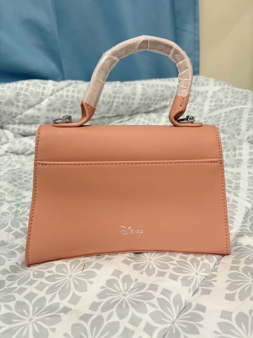 Disney Mickey Mouse Pink Top Handle Bag (Category: Shoulder Bags) located in Manila. Submitted by vengonflo (Listing ID 1459542959, Image 2). Description: - Adorable pink Disney handbag - Original Disney Bag - Features a charming Mickey Mouse clasp - Subtle Disney logo on the back - Interior zippered pocket for essentials - Handle still has protective plastic wrap - A must-have for any Disney enthusiast!.