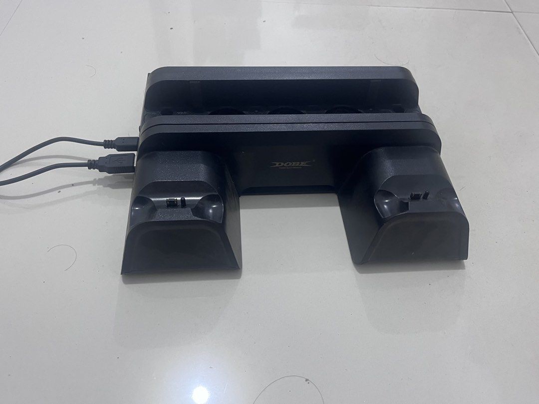 DOBE PS4 Slim Pro Multifunctional Cooling Charging Dock (Category: PlayStation) located in Castillejos. Submitted by anthony88888 (Listing ID 1459577197, Image 1). Description: - Charges up to 2 PS4 Slim/Pro controllers simultaneously. - Built-in cooling fans to prevent overheating. - Connects easily via USB. - Keeps your controllers charged and ready for action..