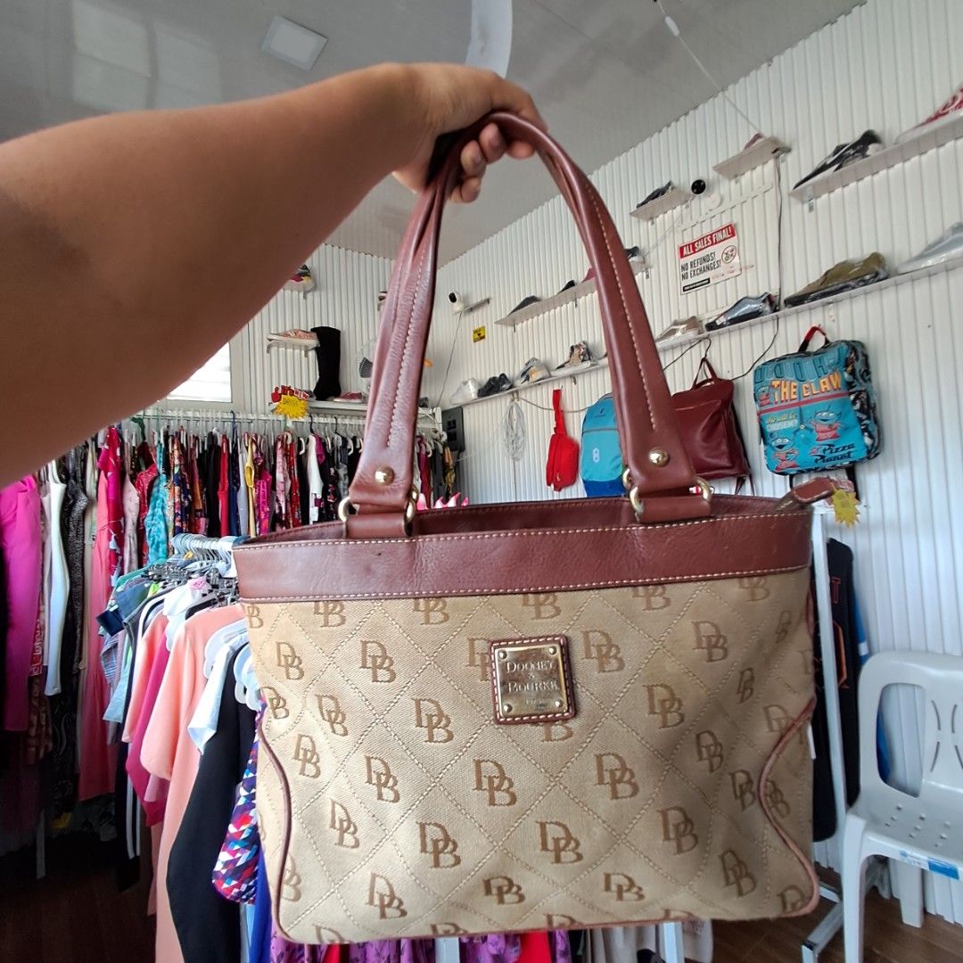 Dooney & Bourke Mini East/West Monogram Handle Tote (Category: Tote Bags) located in Digos. Submitted by richcaliforniaclothingstore (Listing ID 1459560546, Image 2). Description: Manage your exepctation this is not bnew. ♡Authentic/preloved item. Actual photos posted. Please check all photos and details carefully before purchasing. Minor signs of use may be present. Walk in buyers are always welcome!✨️ 📍Location: Lim extension,Digos City Davao 