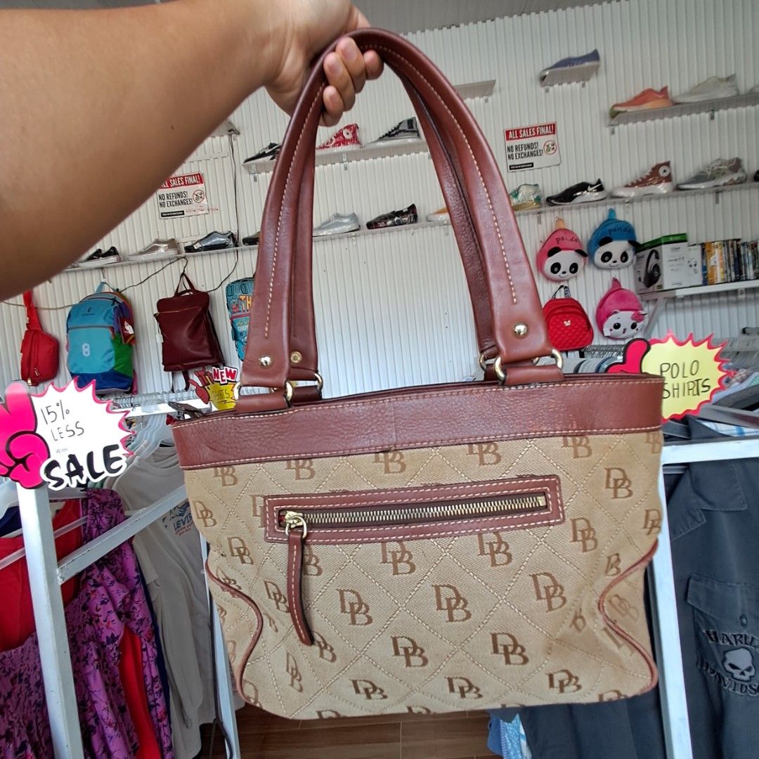 Dooney & Bourke Mini East/West Monogram Handle Tote (Category: Tote Bags) located in Digos. Submitted by richcaliforniaclothingstore (Listing ID 1459560546, Image 3). Description: Manage your exepctation this is not bnew. ♡Authentic/preloved item. Actual photos posted. Please check all photos and details carefully before purchasing. Minor signs of use may be present. Walk in buyers are always welcome!✨️ 📍Location: Lim extension,Digos City Davao 