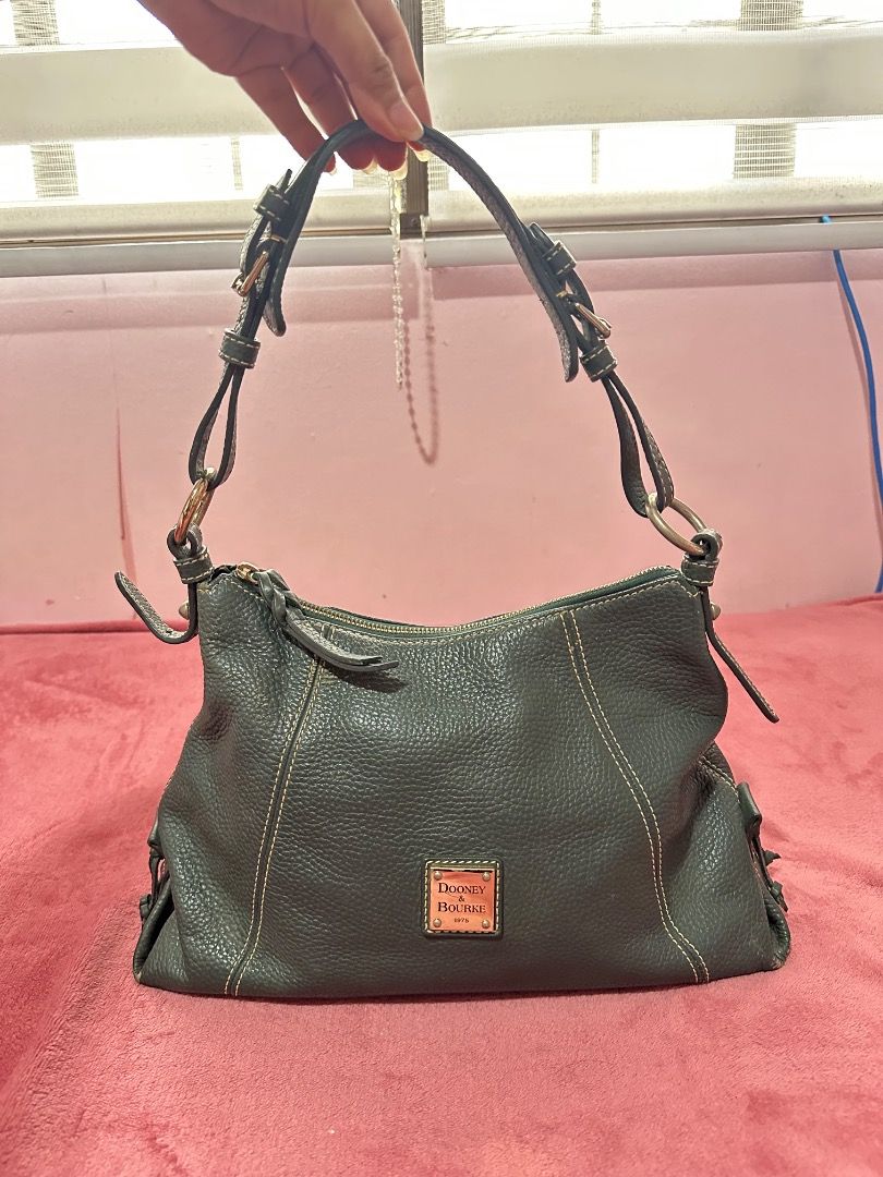 Dooney & Bourke Pebble Grain Leather Shoulder Bag (Category: Luxury Bags & Wallets) located in Caloocan City. Submitted by gandara12345678 (Listing ID 1459601375, Image 2). Description: - Classic Dooney & Bourke shoulder bag - Made from dark green pebble grain leather - Interior with multiple pockets for organization - Secure zipper closure - Timeless and perfect for carrying everyday essentials.