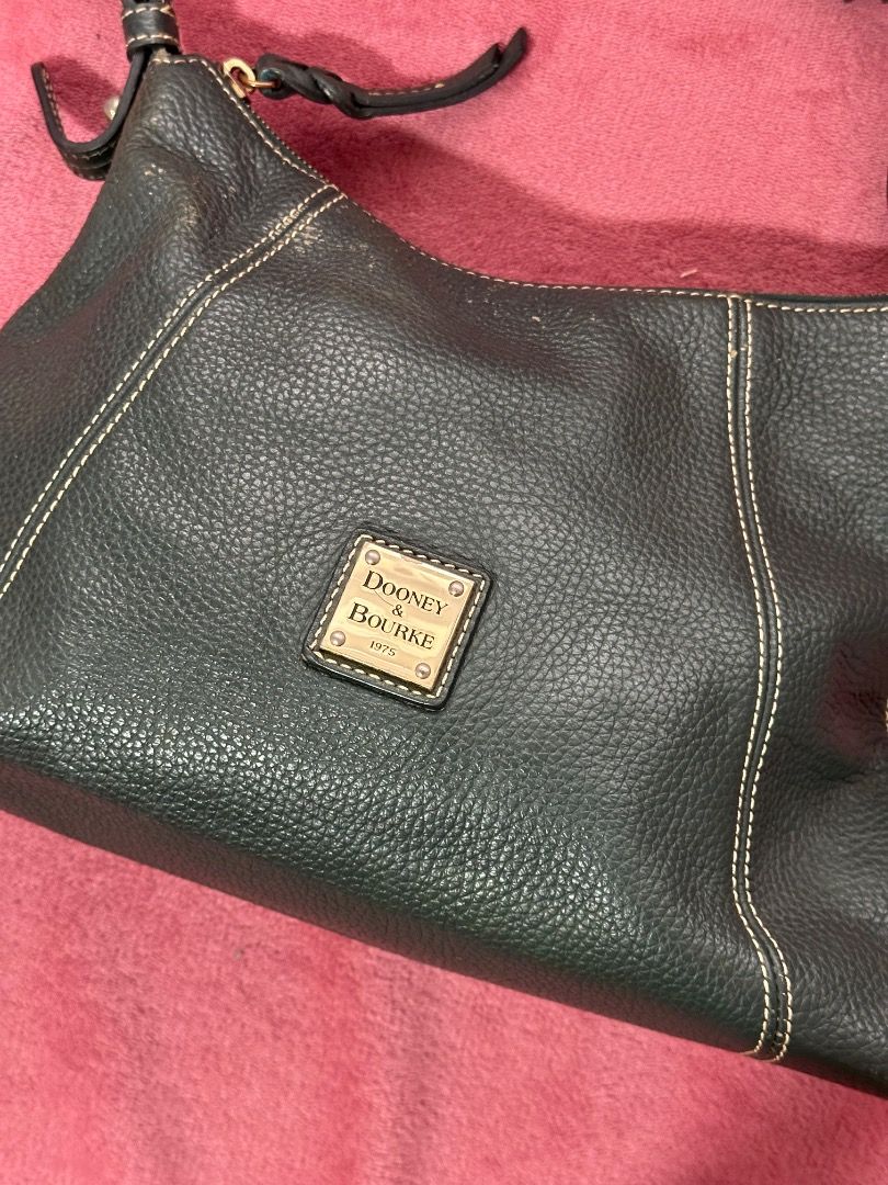 Dooney & Bourke Pebble Grain Leather Shoulder Bag (Category: Luxury Bags & Wallets) located in Caloocan City. Submitted by gandara12345678 (Listing ID 1459601375, Image 3). Description: - Classic Dooney & Bourke shoulder bag - Made from dark green pebble grain leather - Interior with multiple pockets for organization - Secure zipper closure - Timeless and perfect for carrying everyday essentials.