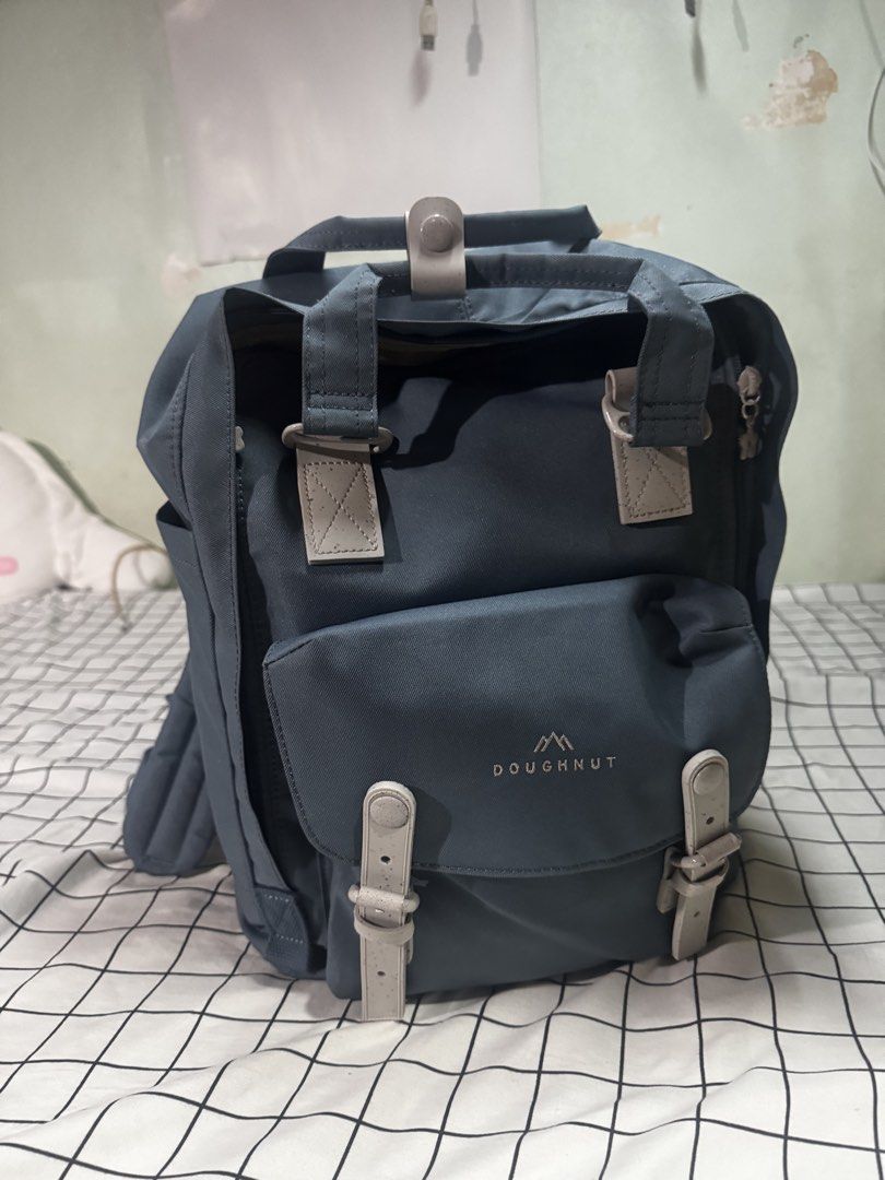 Doughnut Macaroon Backpack (Category: Backpacks) located in Mandaluyong City. Submitted by maejoselle (Listing ID 1459571275, Image 1). Description: - Stylish blue-grey Doughnut Macaroon backpack - Features a charming floral lining inside - Multiple pockets for excellent organization - Adjustable straps for a comfortable fit Rubber yung straps - Ideal for daily use or short getaways Used for a week lang. Kakabili lang last month. I realized di ko