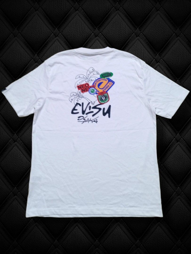 EVISU White Graphic Print T-Shirt I Tee (Category: Tshirts & Polo Shirts ) located in Aguinaldo. Submitted by baguioukayukay2600 (Listing ID 1459515332, Image 1). Description: - White Evisu t-shirt - Features a cool graphic print on the back - Includes Evisu branding and colorful patches - Short sleeves and crew neck design - Ideal for casual wear.