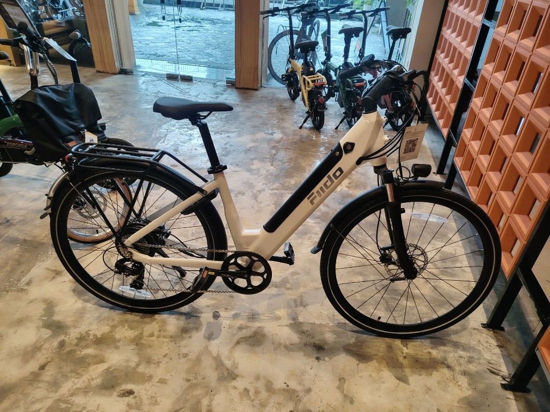 FIIDO Electric Bike White Step-Through Frame (Category: Bicycles) located in Manila. Submitted by jomspopcycle (Listing ID 1459514367, Image 3). Description: - White FIIDO electric bike - Easy step-through frame for convenient mounting - Includes rear rack and fenders - Reliable disc brakes on both wheels - Front suspension fork for a smoother ride - Ideal for daily commutes and leisurely rides around town.