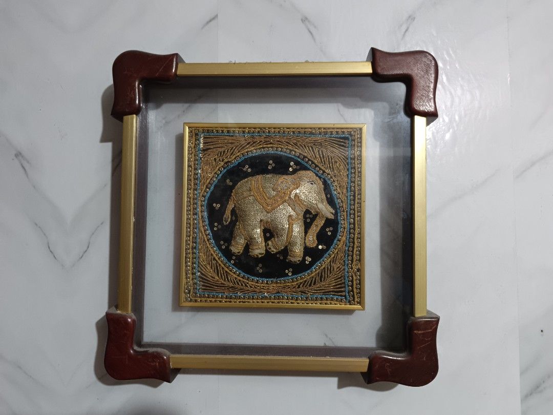 Framed Elephant Wall Art - Gold and Black (Category: Frames & Pictures) located in San Pedro. Submitted by kanor1234 (Listing ID 1459636301, Image 2). Description: - Beautiful framed artwork with a detailed elephant design. - Intricate embroidery using gold thread and sequins. - Set against a striking black background. - Housed in a square frame with elegant gold metal accents. - Dark brown corner protectors for added detail. - A unique and eye-c