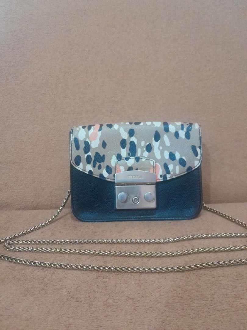 Furla Mini Crossbody Bag with Chain Strap (Category: Luxury Bags & Wallets) located in Quezon City. Submitted by lalaine.r (Listing ID 1459511473, Image 1). Description: - Cute Furla mini bag - Black and patterned leather - Gold chain strap - Gold-toned clasp closure - Small size, ideal for essentials - Perfect for nights out or traveling light - Signs of use in hardware.