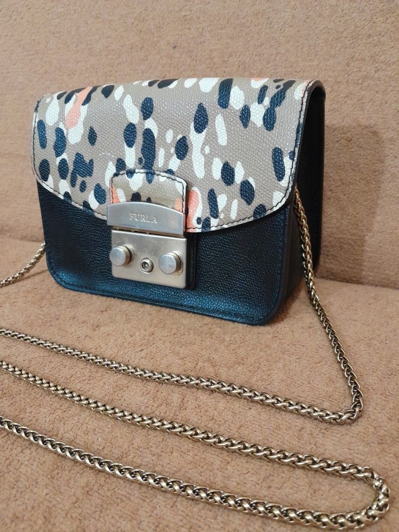 Furla Mini Crossbody Bag with Chain Strap (Category: Luxury Bags & Wallets) located in Quezon City. Submitted by lalaine.r (Listing ID 1459511473, Image 2). Description: - Cute Furla mini bag - Black and patterned leather - Gold chain strap - Gold-toned clasp closure - Small size, ideal for essentials - Perfect for nights out or traveling light - Signs of use in hardware.